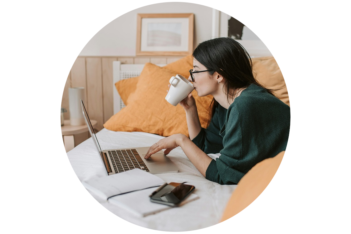 woman drinking coffee using laptop